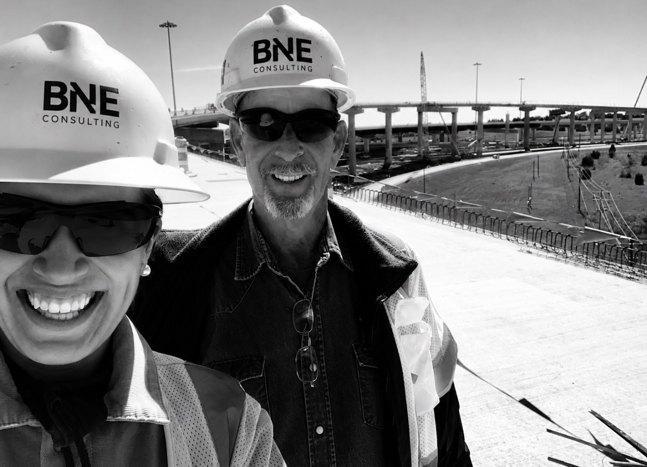 BNE consultants wearing branded hard hats at a construction site