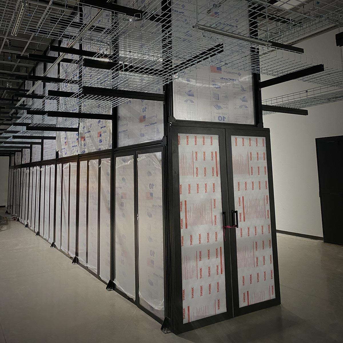 Hot aisle containment aisle with overhead cable tray during installation