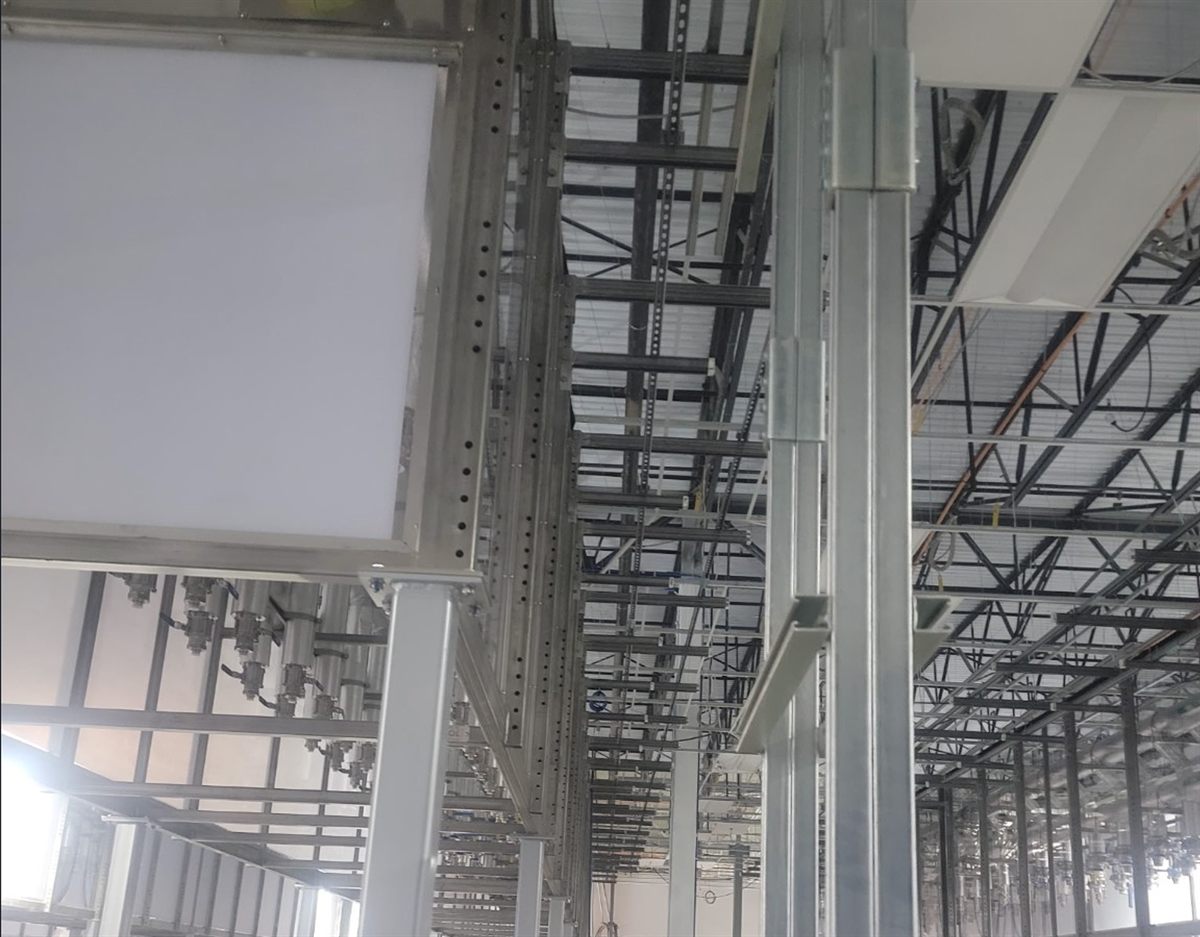 Overhead structural steel supports and trapeze framing in a data center